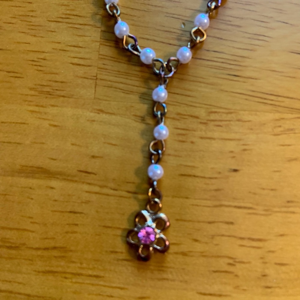 Vintage bib style necklace with pink-hued faux pearls and rhinestone-set charm